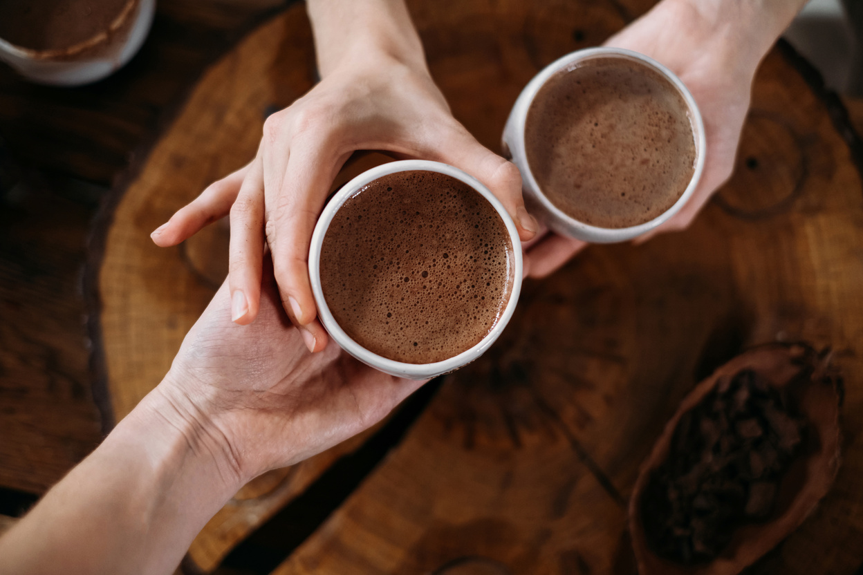 Person Holding Cups of Chocolate Drink