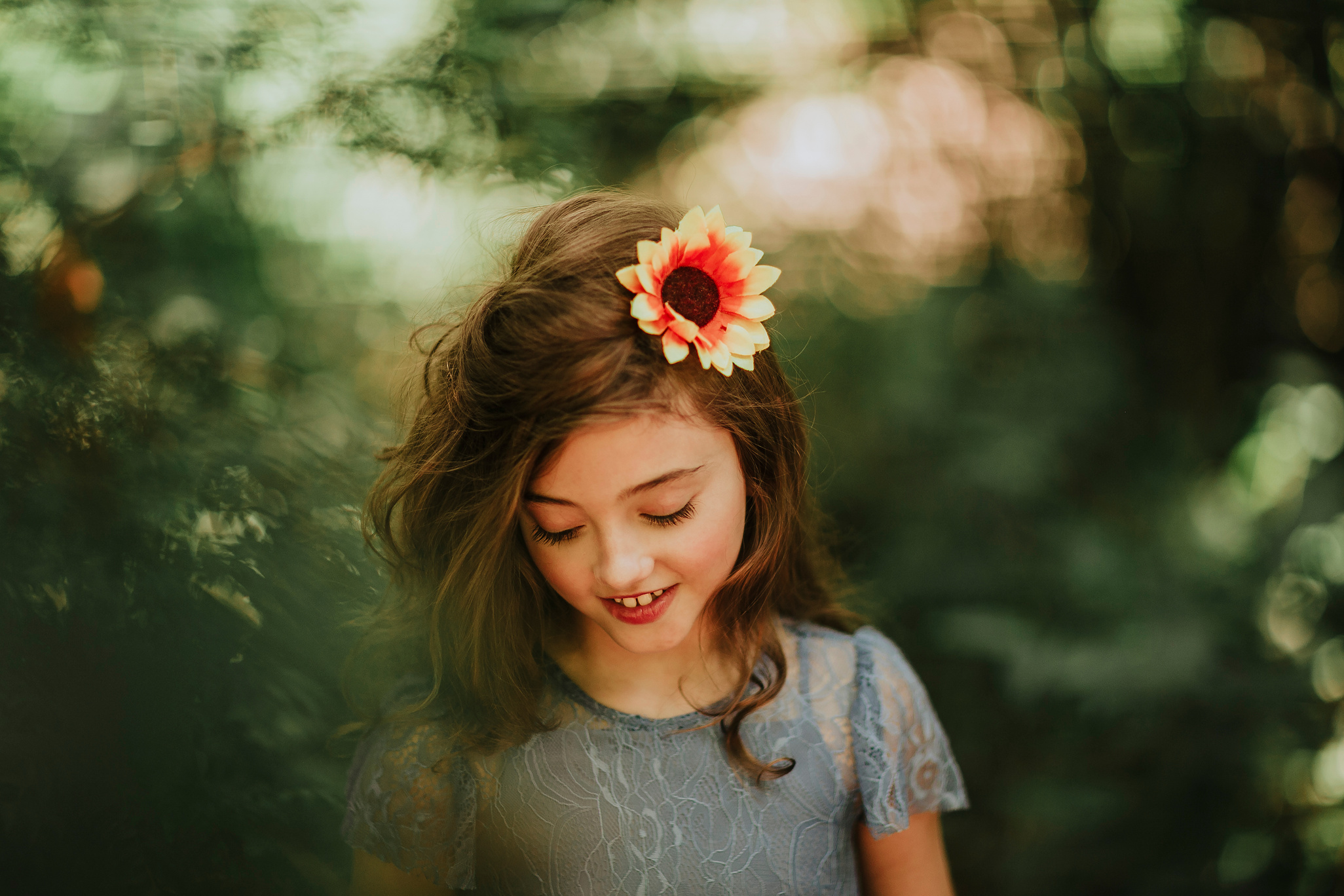 Little Girl in Forest with Flower in Hair